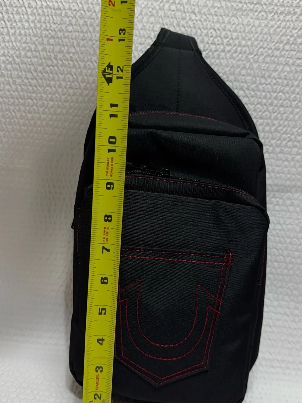 True religion travel sling black bag red horseshoe front